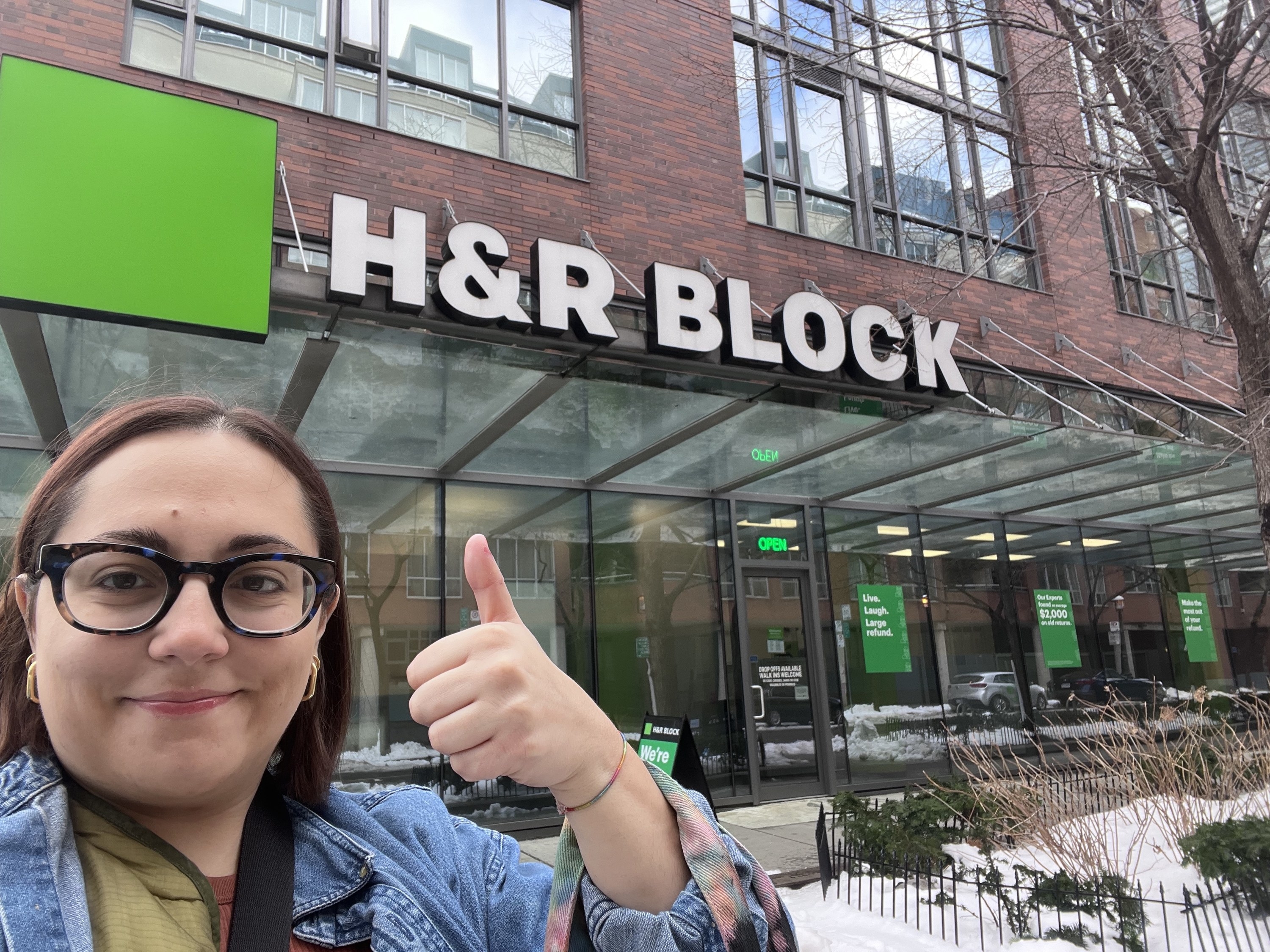 author thumbs up in front of h&amp;r block