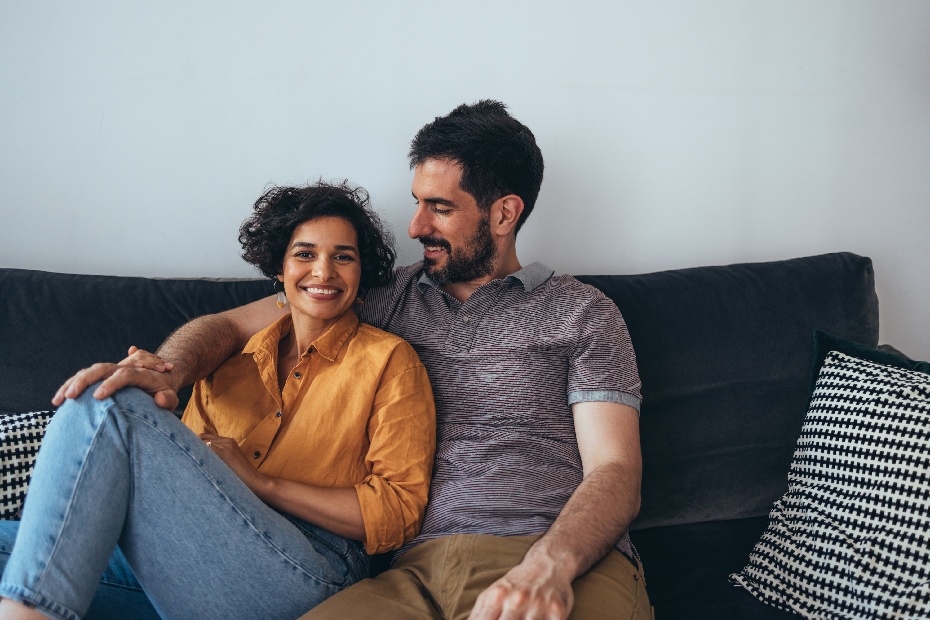 A couple sitting together on the couch