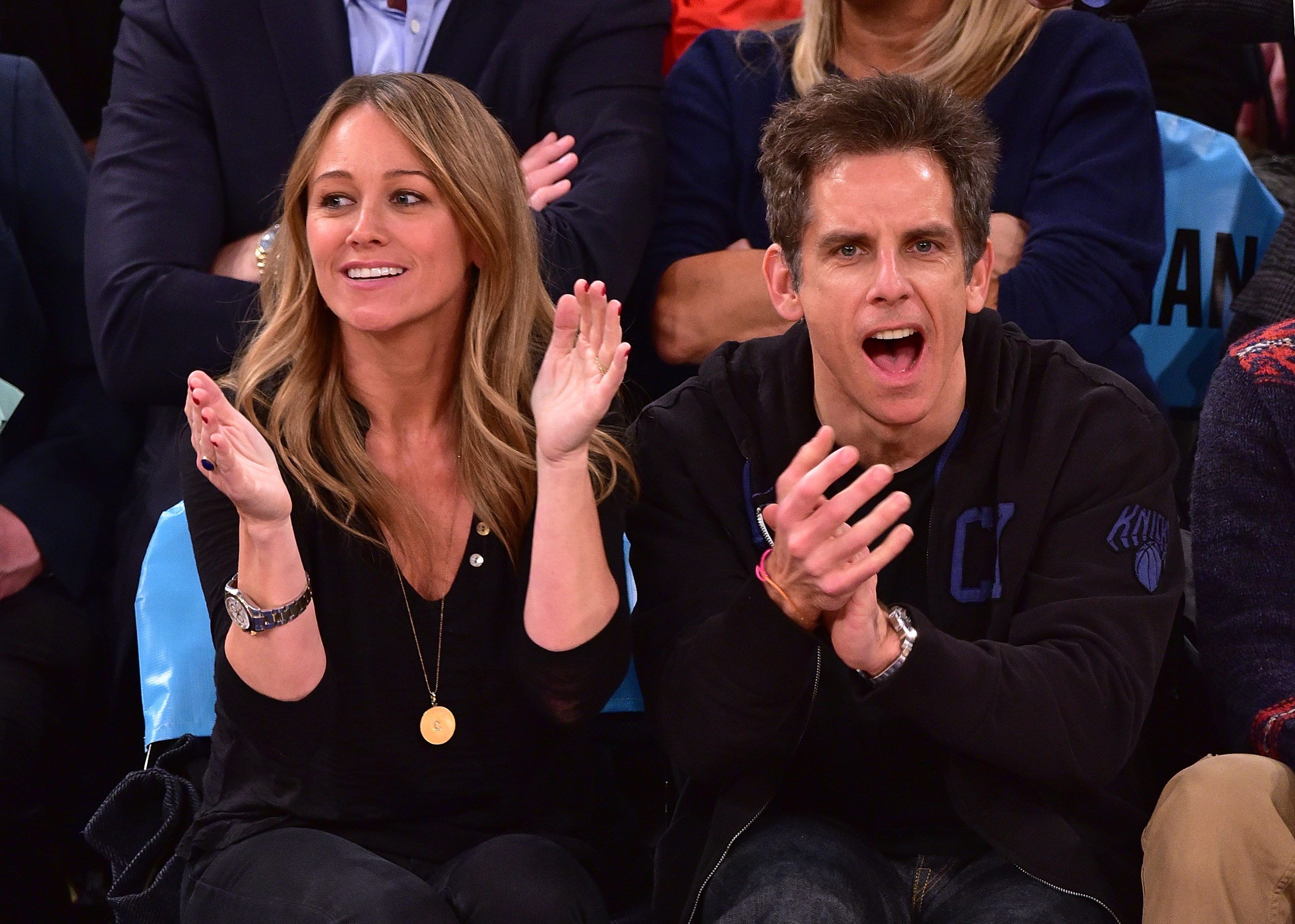 The couple cheering at a sporting event