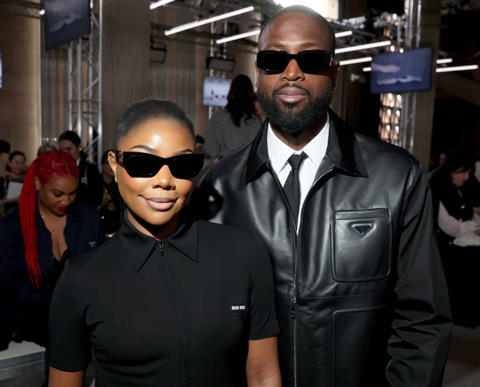 Dwayne and Gabrielle pose together at a fashion show, both in sunglasses