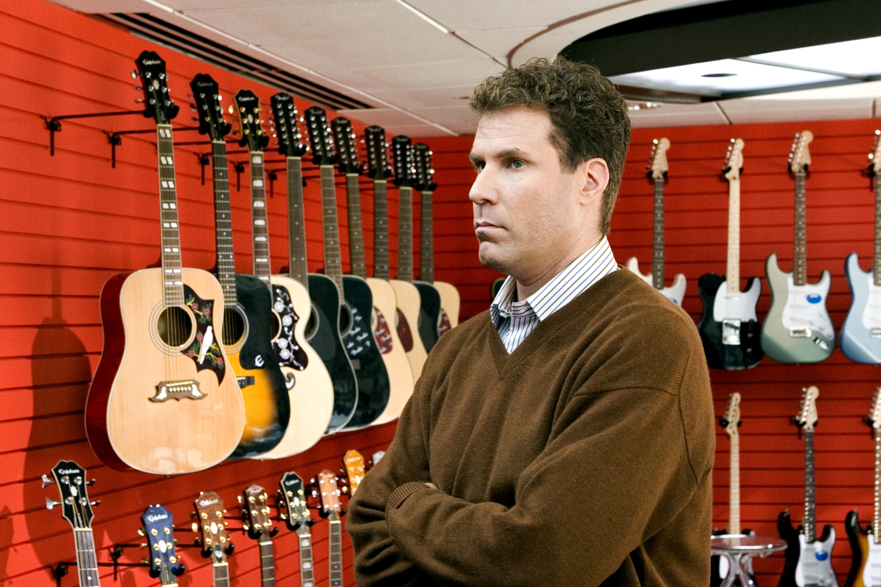 A man standing in a guitar store