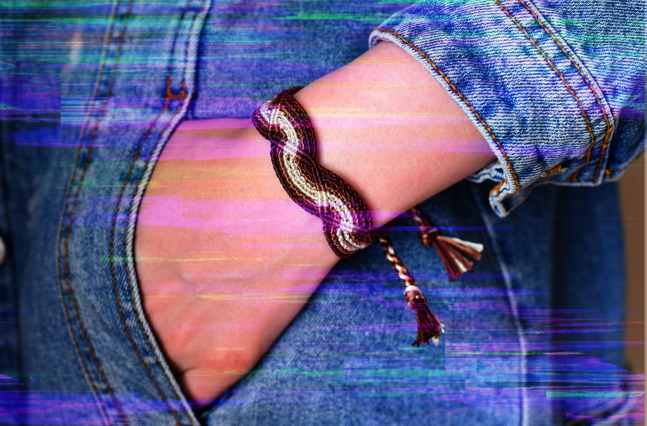 Closeup of someone&#x27;s hand in their pocket with a bracelet on their wrist