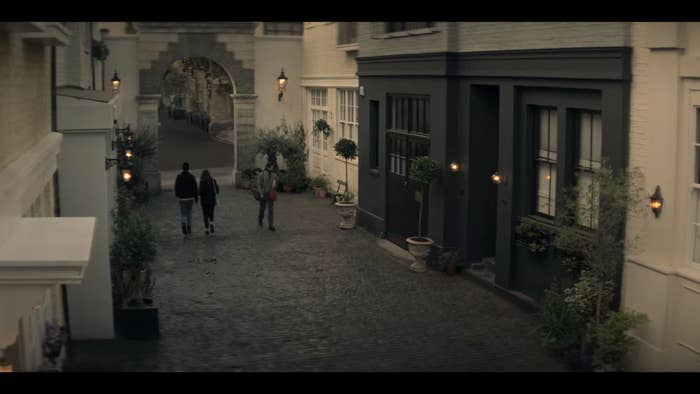 Joe walking on a cobblestone street outside his building