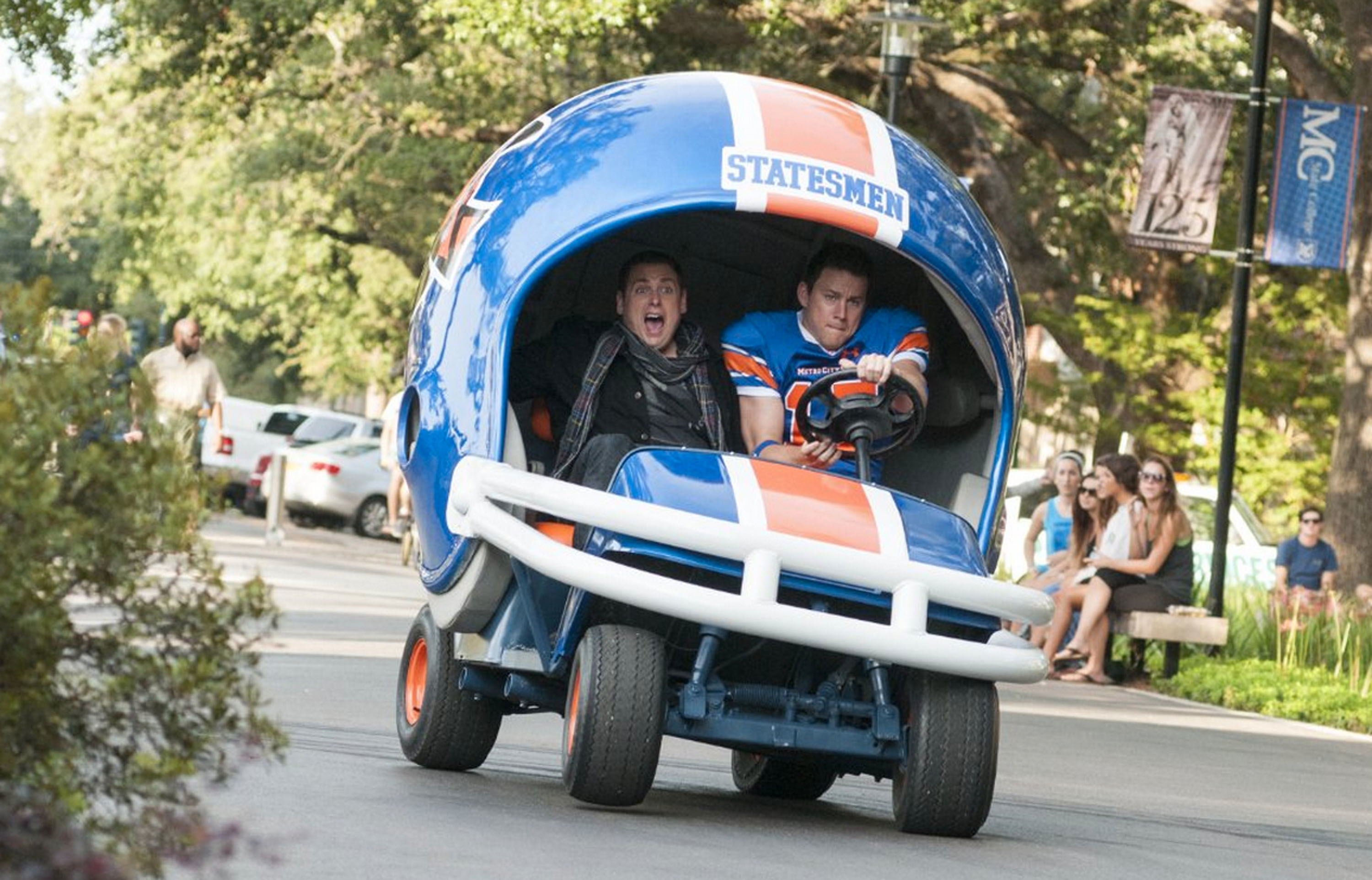 Jonah Hill and Channing Tatum ride in a motorized football helmet