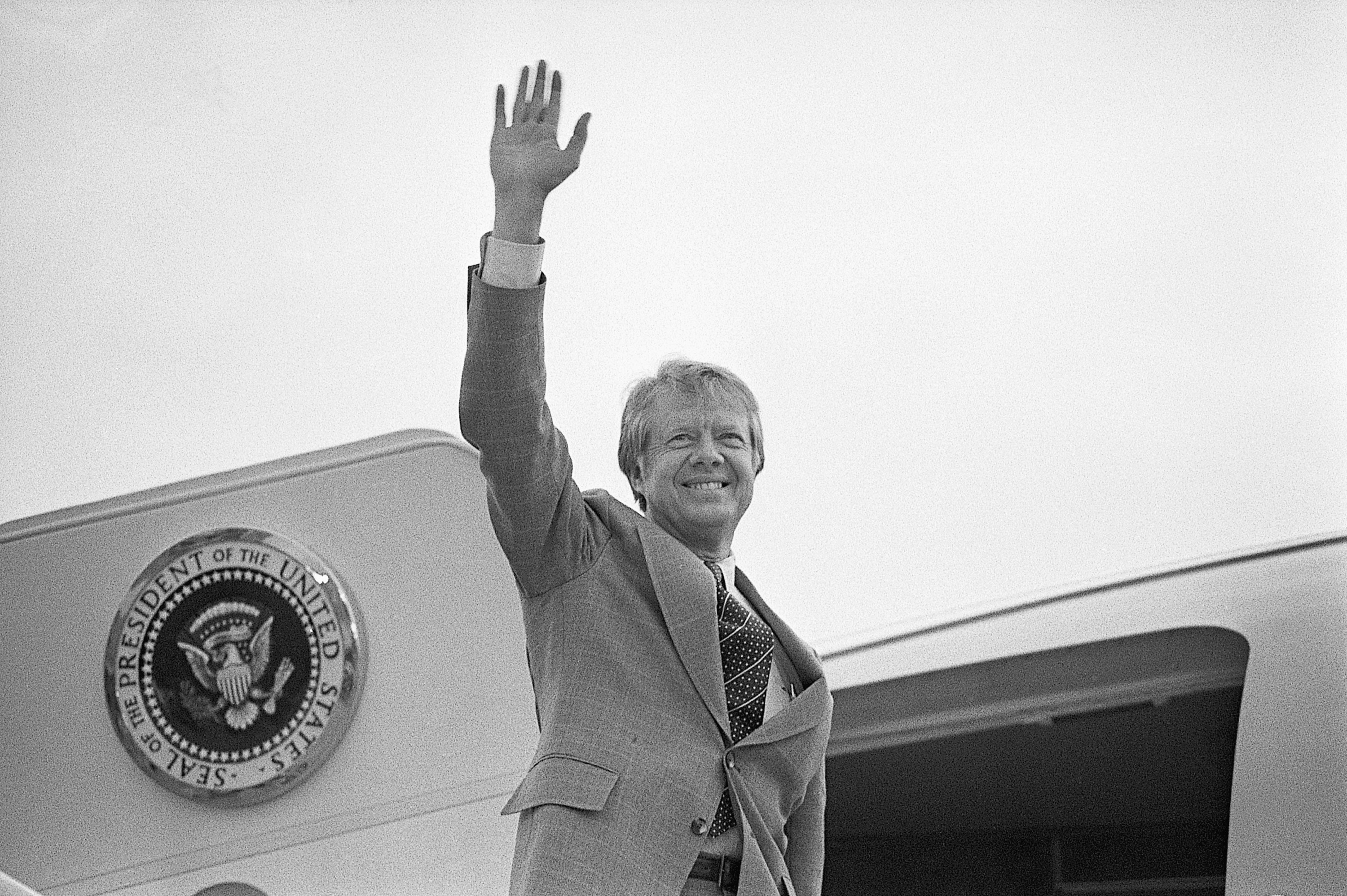 President Carter waves as he boards a helicopter on the White House lawn to fly to Camp David, Maryland