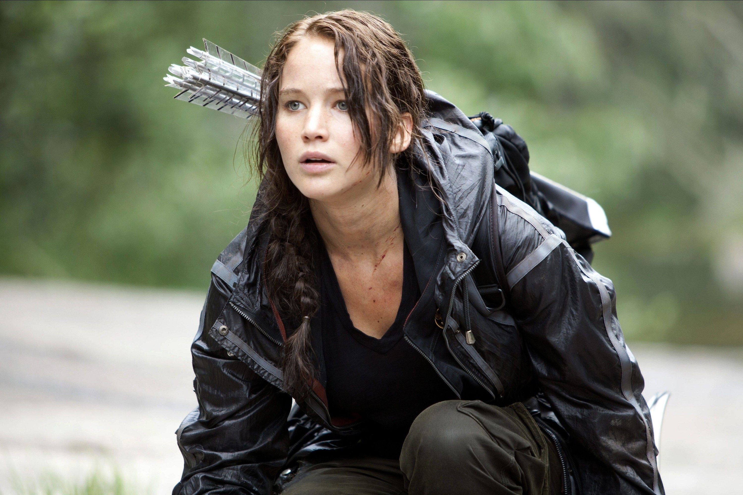 Jennifer Lawrence kneels in a windbreaker while looking visibly concerned