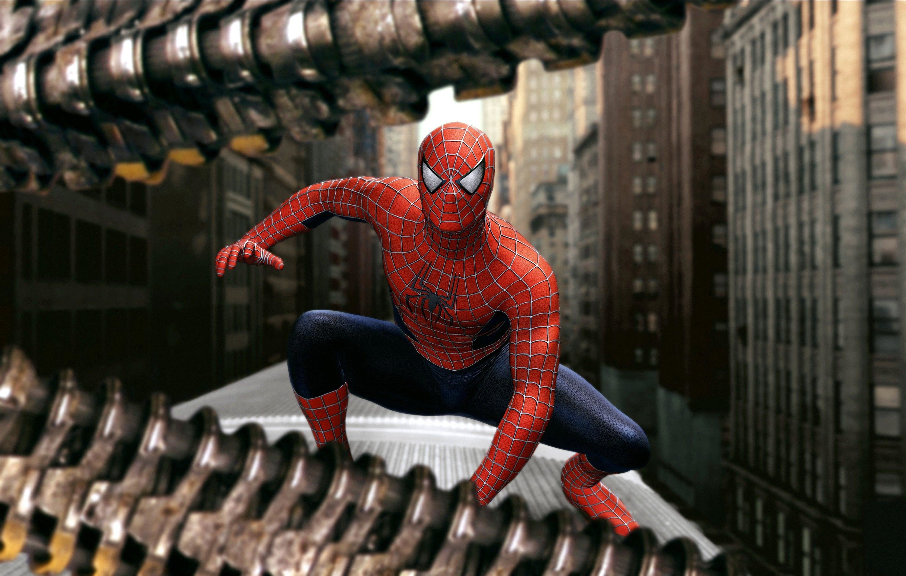 Spider-Man crouches on top of a subway train in front of industrial metal tentacles