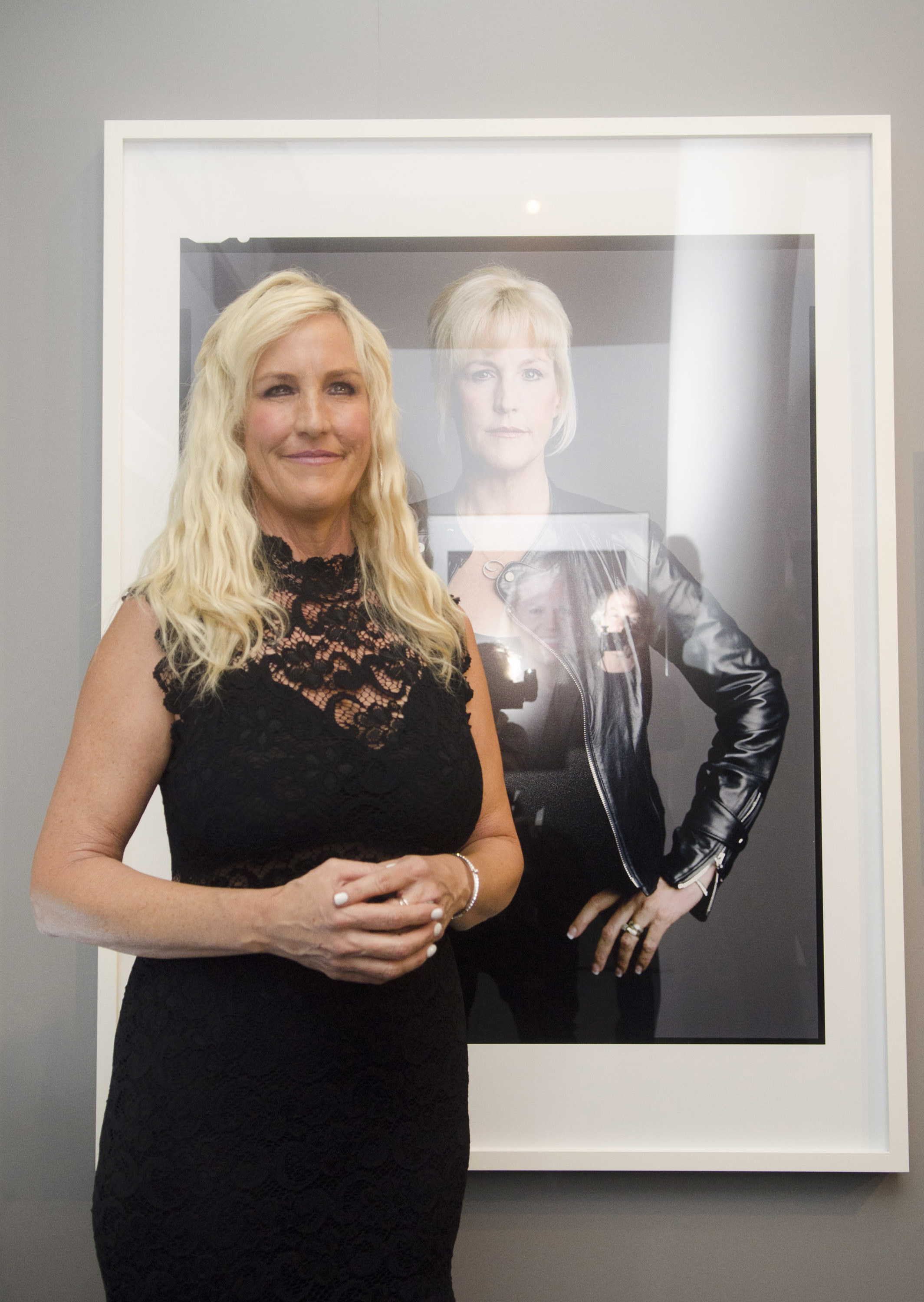 Erin Brockovich standing in front of a photograph of herself at the opening of &quot;The Boomer List: Photographs by Timothy Greenfield-Sanders&quot;