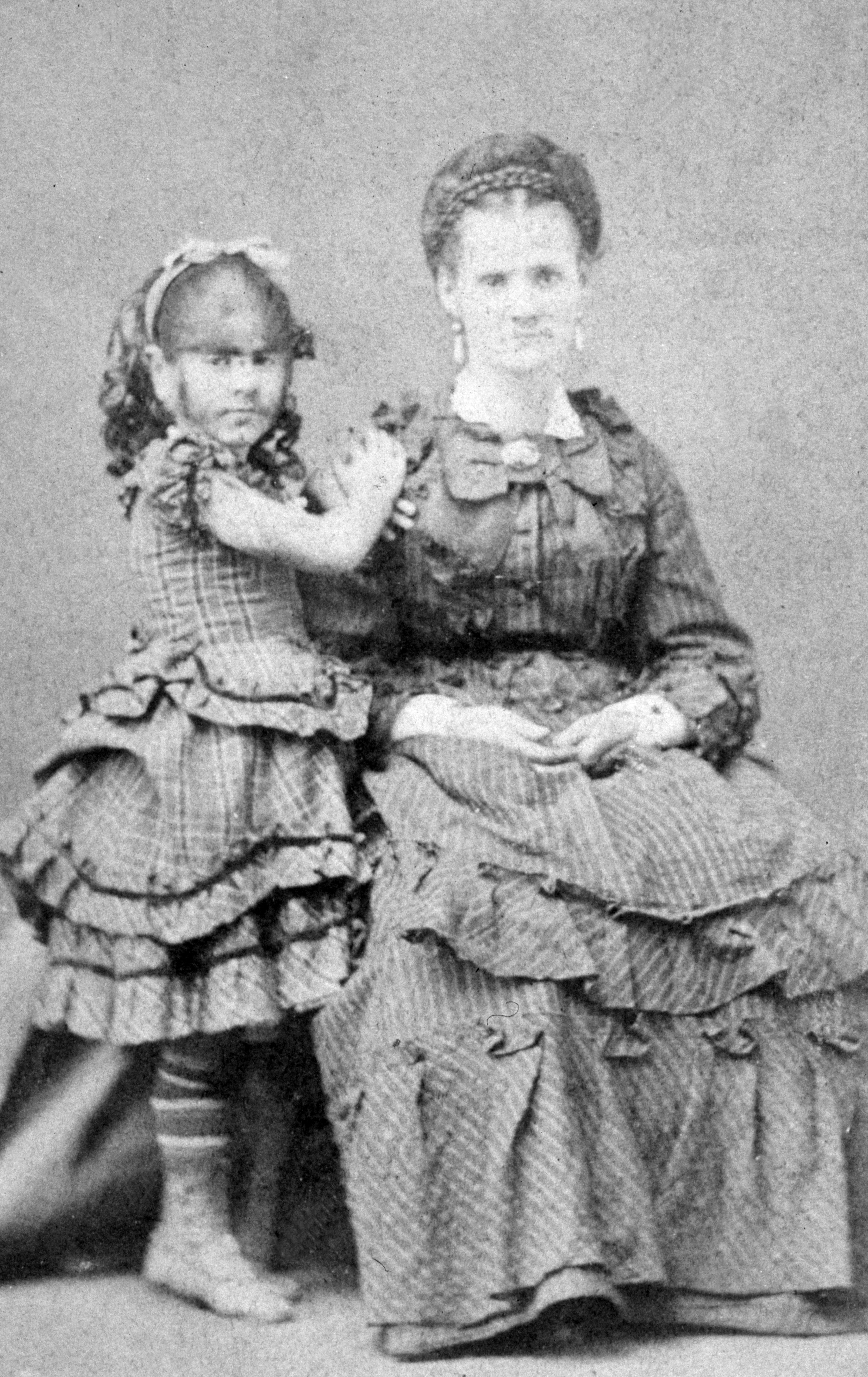 Portrait of Annie Jones, the Bearded Girl (1865–1902), standing with her mother in the 1870s