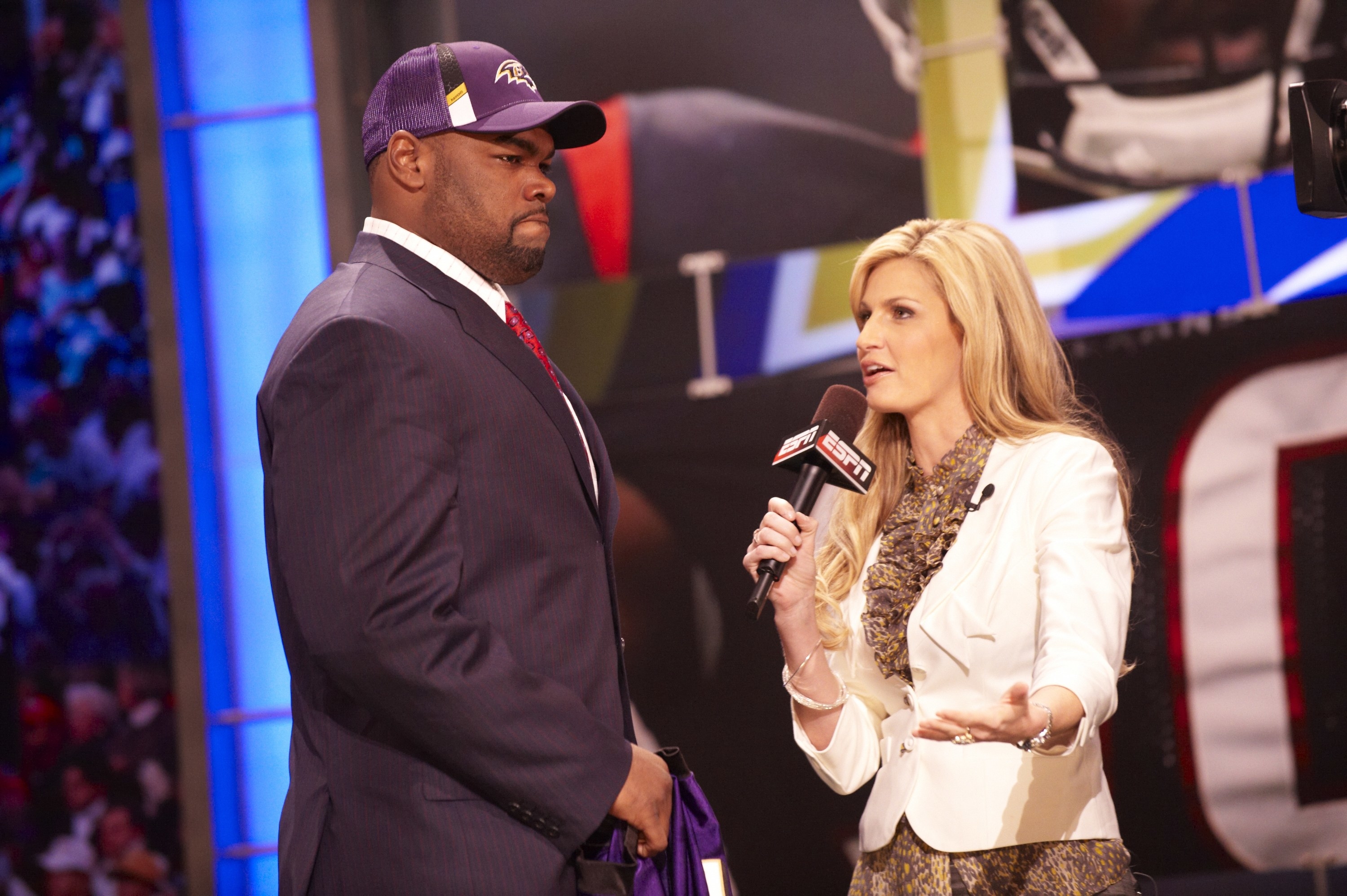 Michael Oher onstage with ESPN announcer Erin Andrews during media interview at Radio City Music Hall