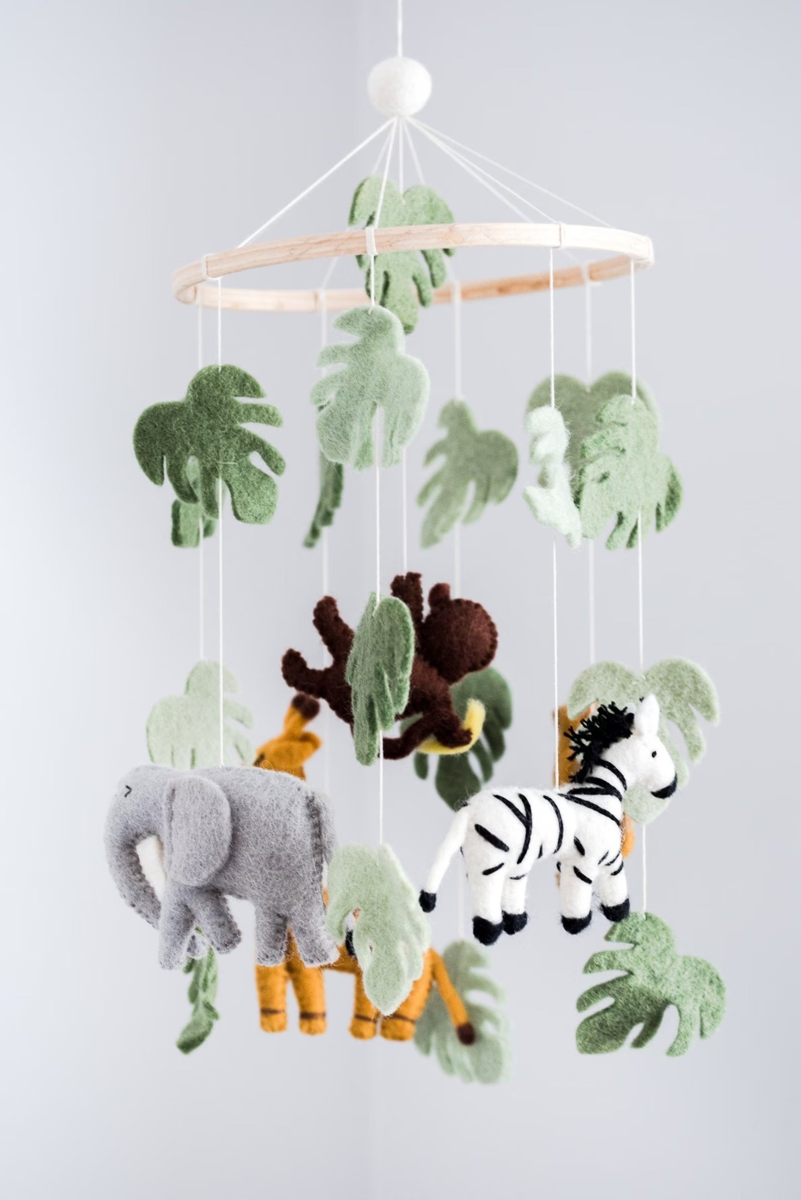 A mobile with felt animals is shown