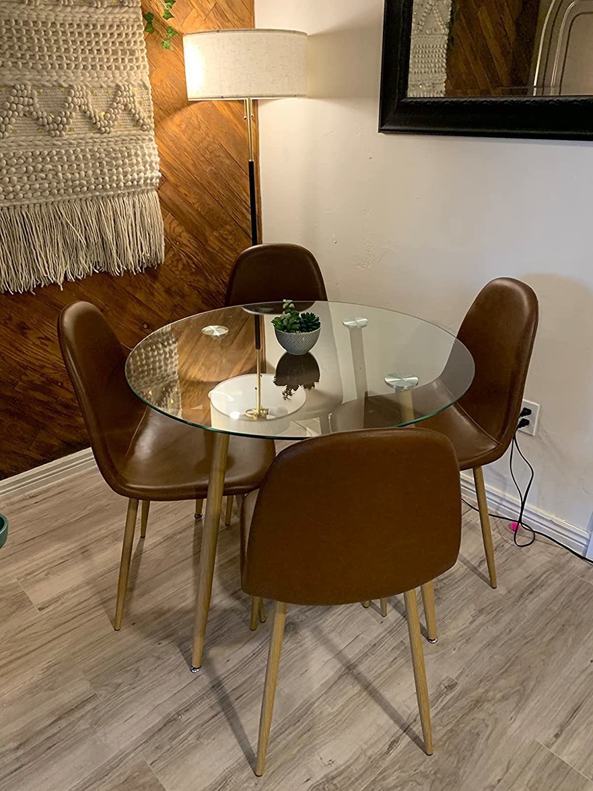 Reviewer image of brown leather chairs around a glass dining table
