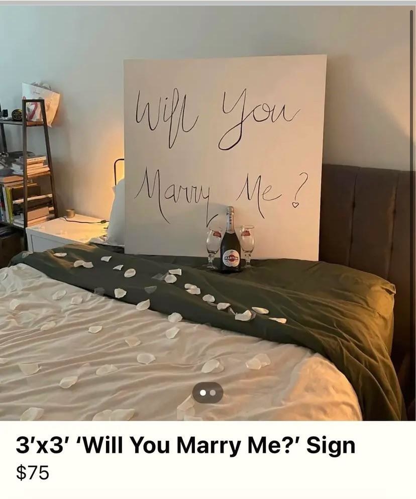 &quot;Will you marry me?&quot; sign on a bed with petals, for sale for $75