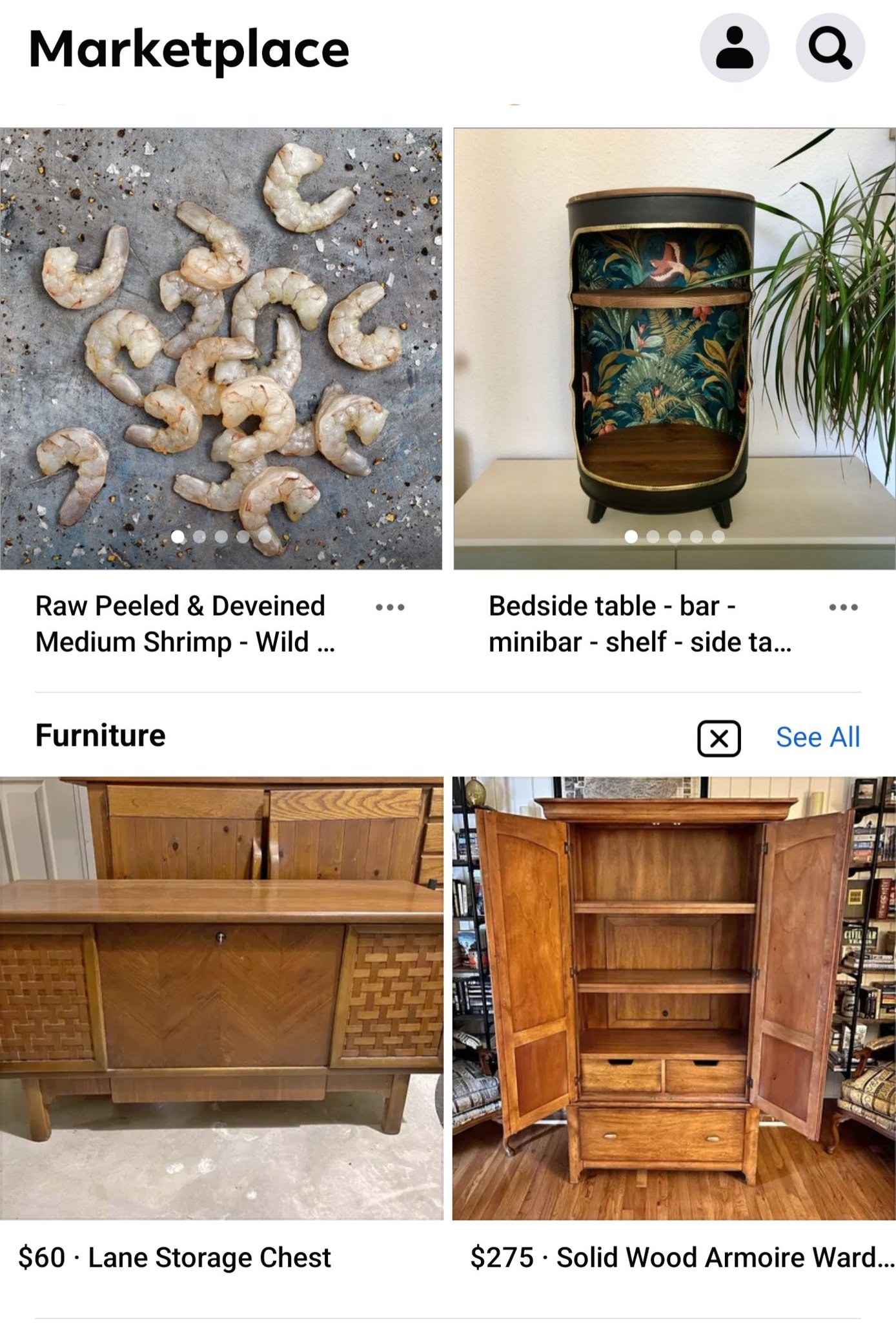Raw peeled and deveined shrimp on the floor for sale, alongside wooden armoires and storage chests and a bedside bar