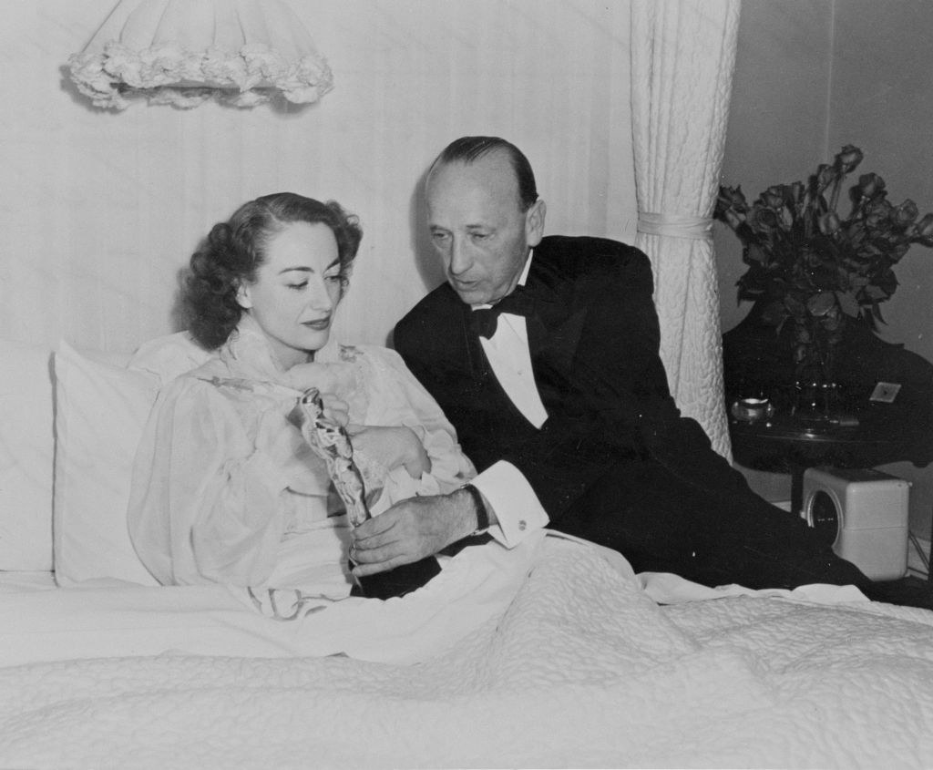 Joan with her award in bed