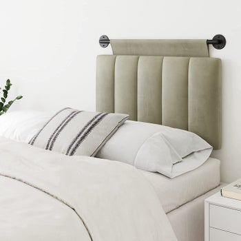 green twin-size headboard on black rod
