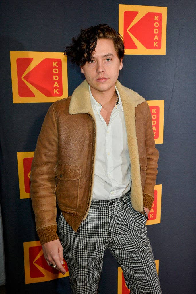Cole on the red carpet in a leather jacket and printed pants