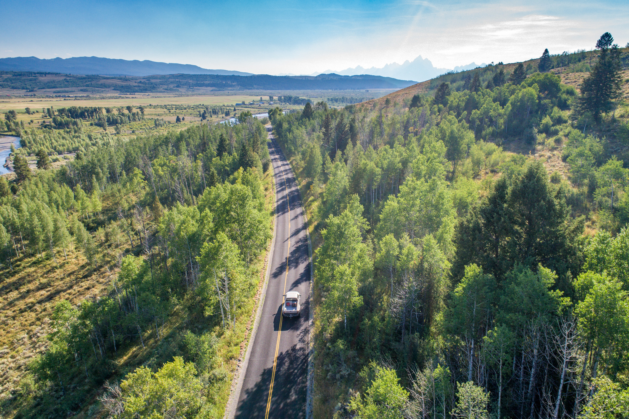 A lone truck on a mountain road.