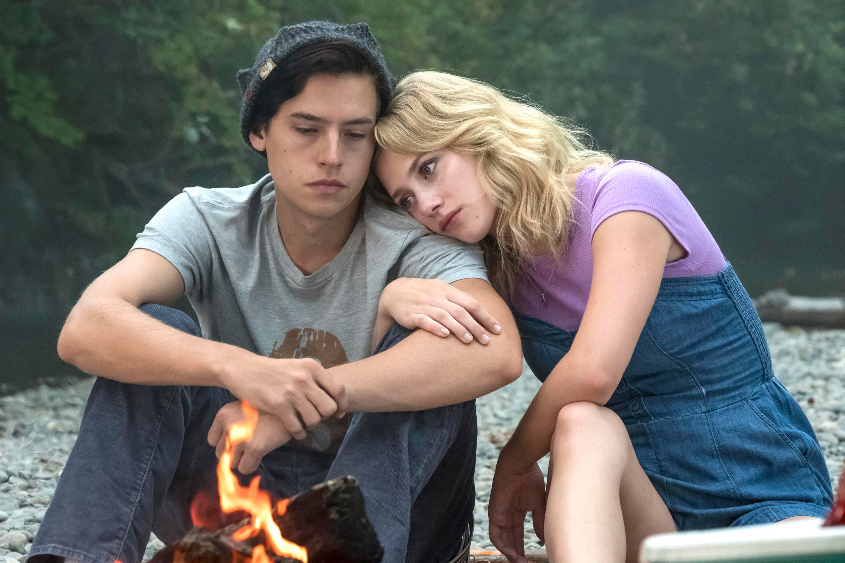 lili&#x27;s character putting her head on cole&#x27;s shoulder in front of a fire