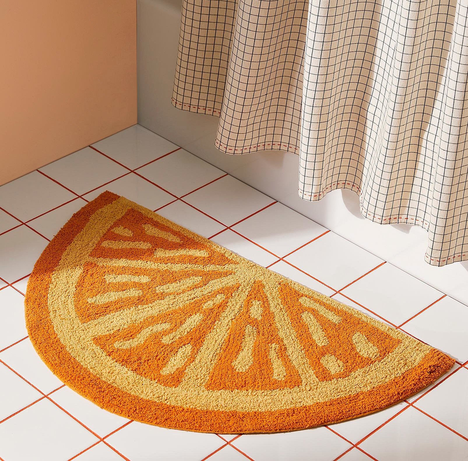 the bath mat on a bathroom floor in front of a shower