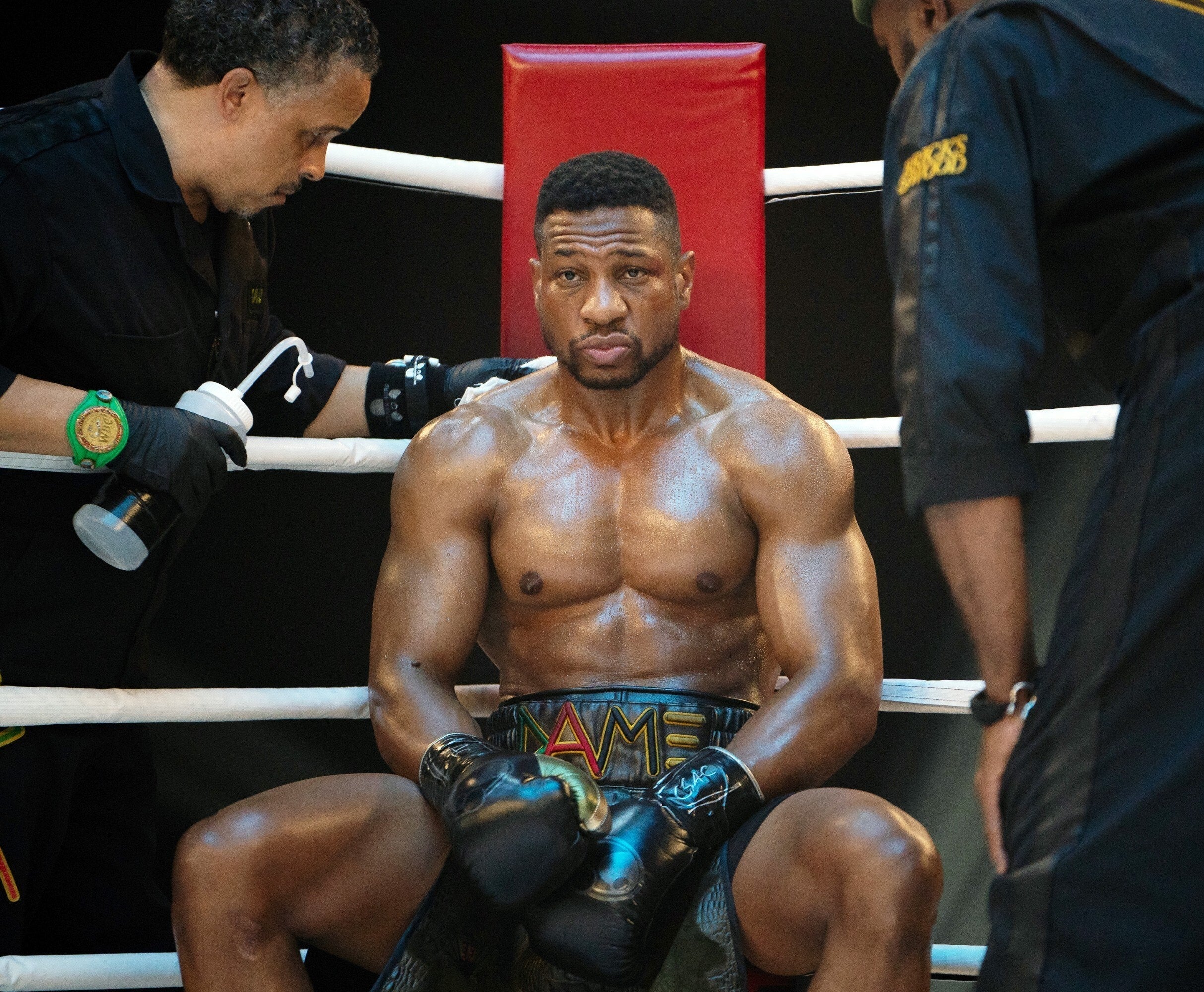Jonathan Majors and two ring guys in Creed III