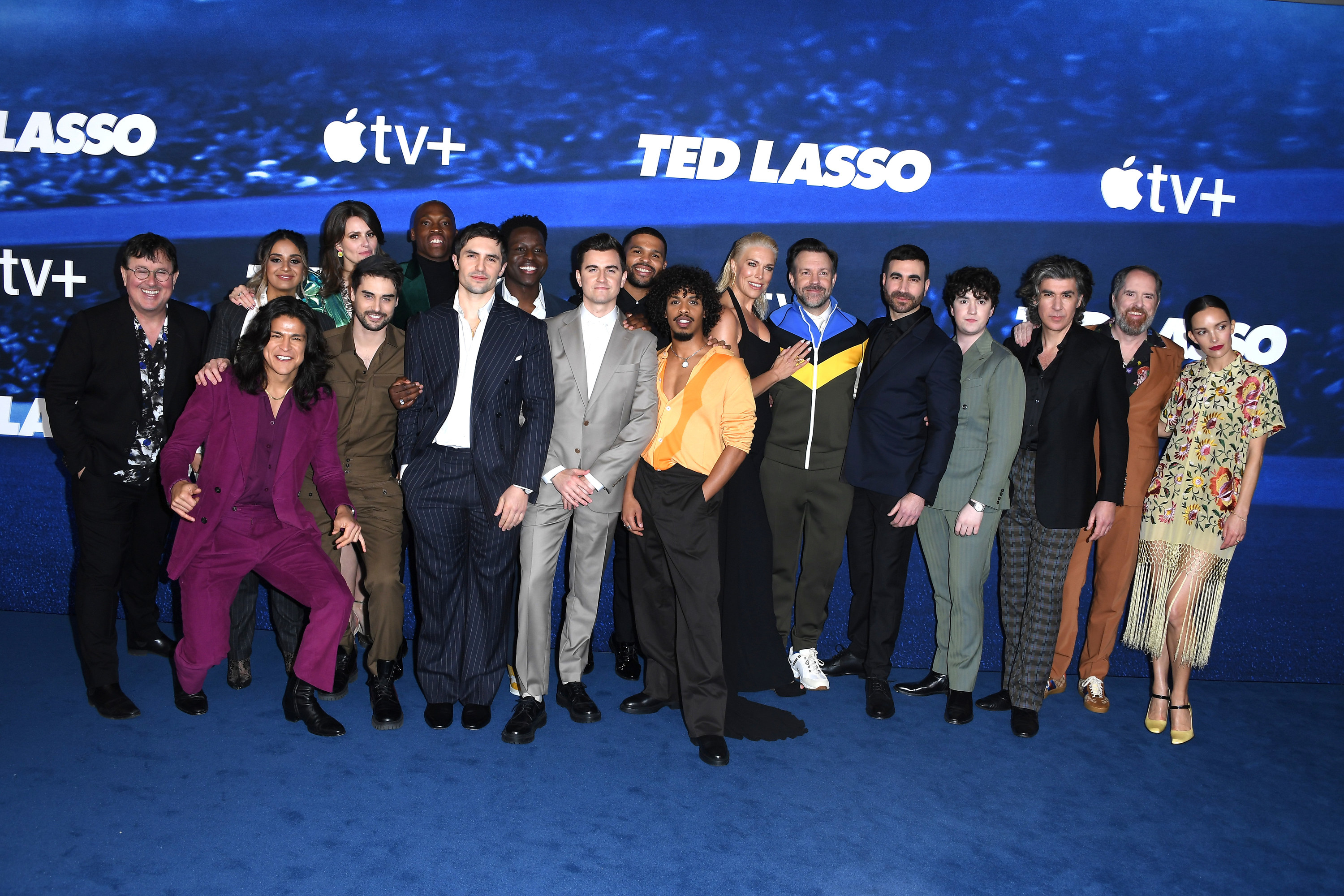 Jason and the entire cast pose on a red carpet