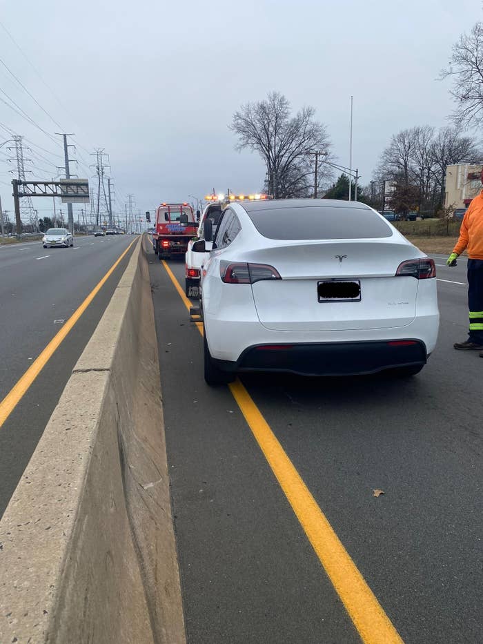 A tow-truck tows Patel's Tesla