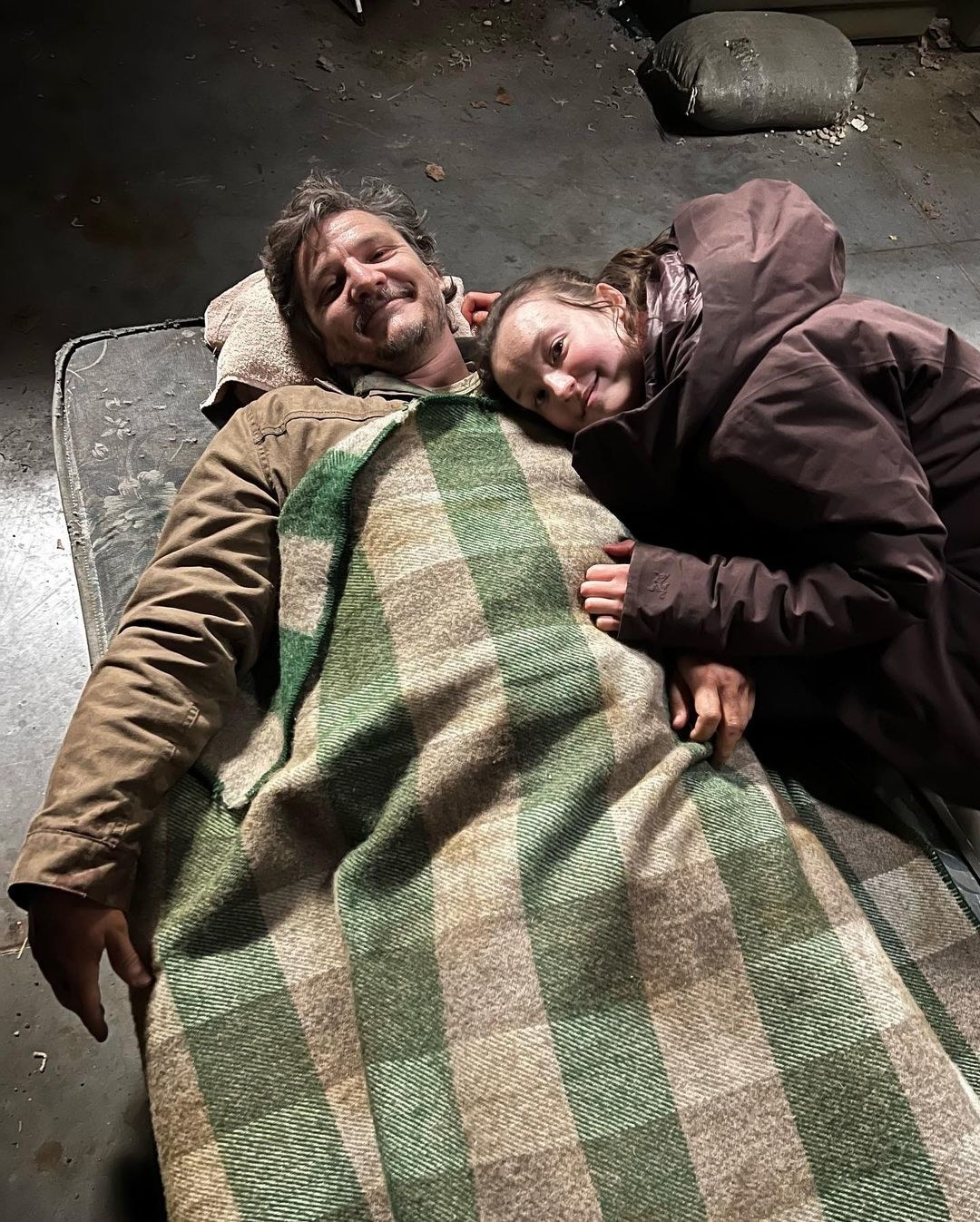 the two cuddled up while on set on a dirty blanket and mattress