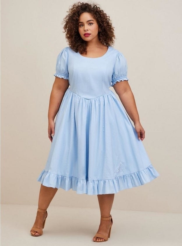 Model wearing blue dress with heels