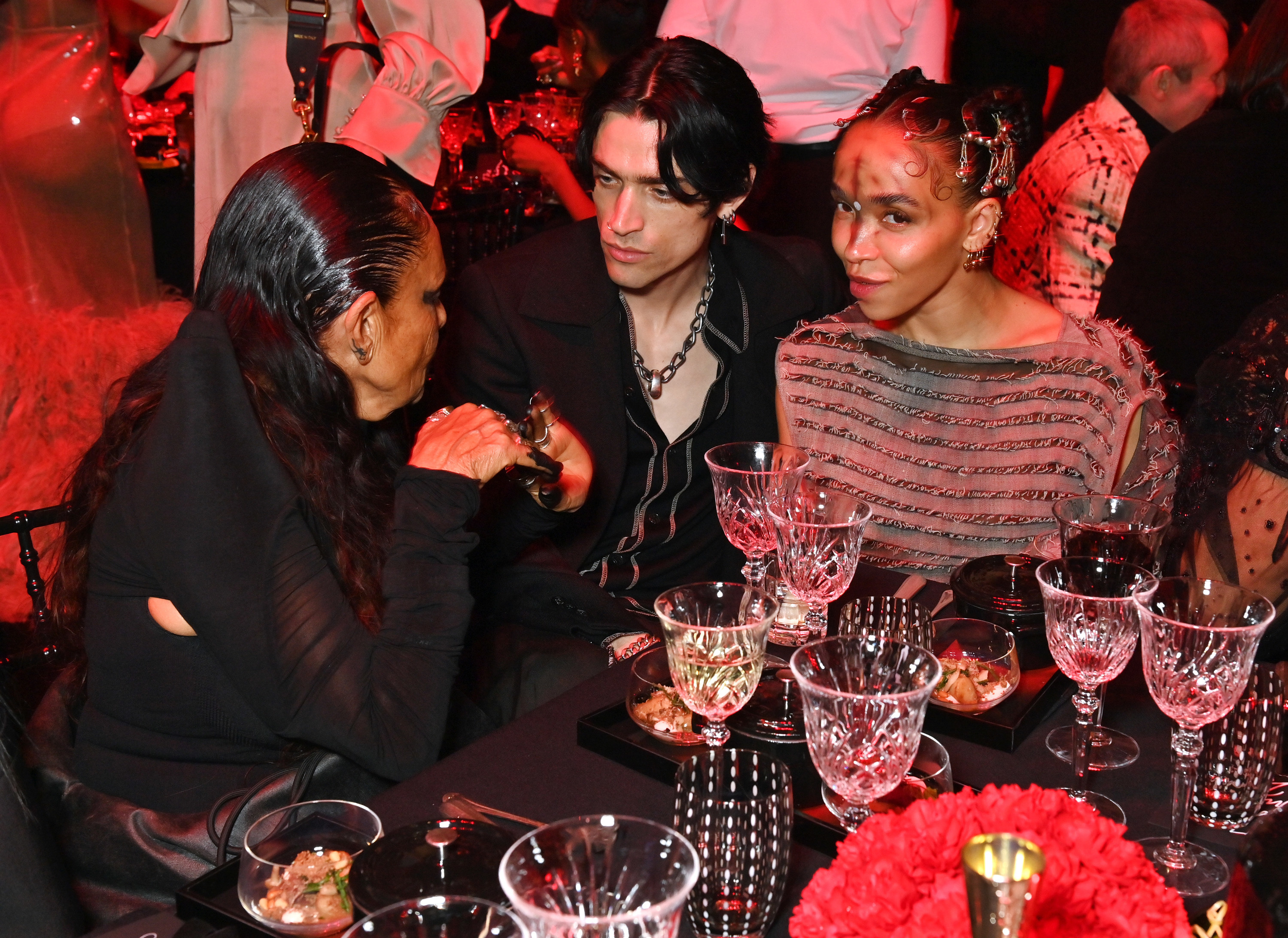 Twigs and Jordan sit next to each other at a table at an event