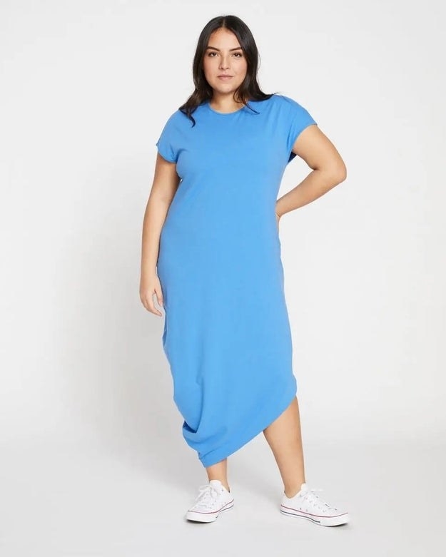 Model wearing blue dress with white shoes
