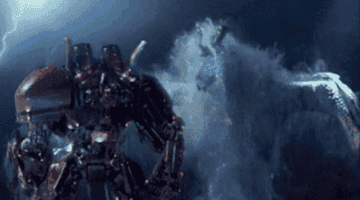 A battle from &quot;Pacific Rim&quot; taking place at night and in the water