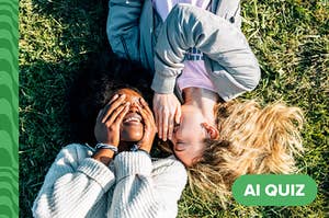 Two women lying on a lawn having fun