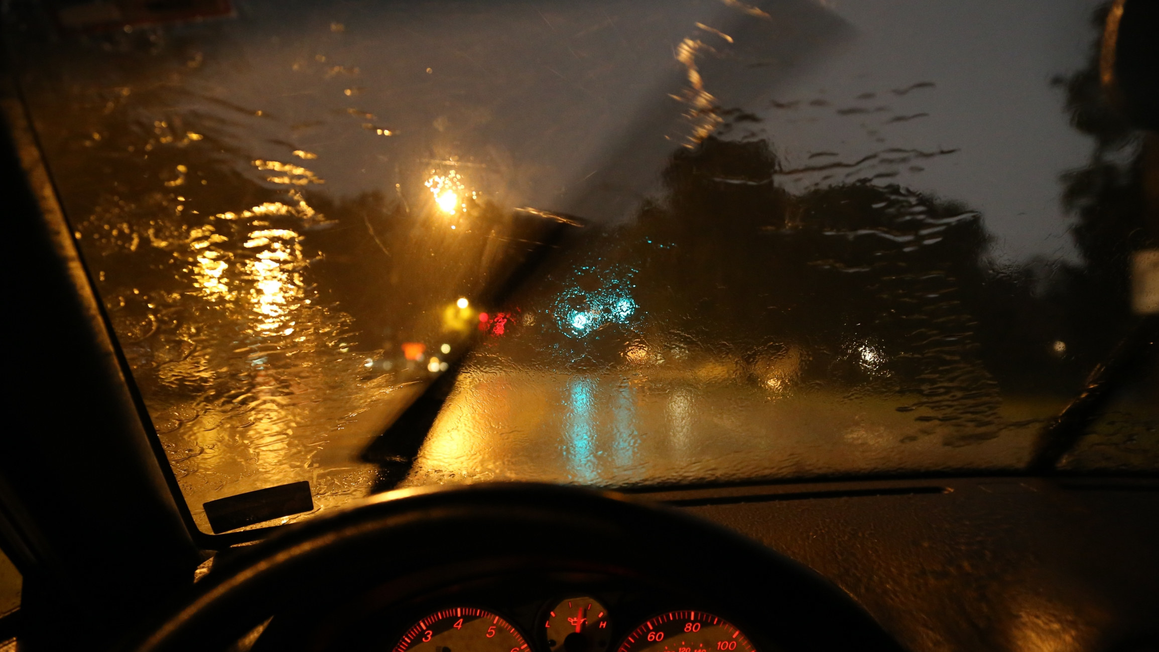 View of the road from a car on a rainy night