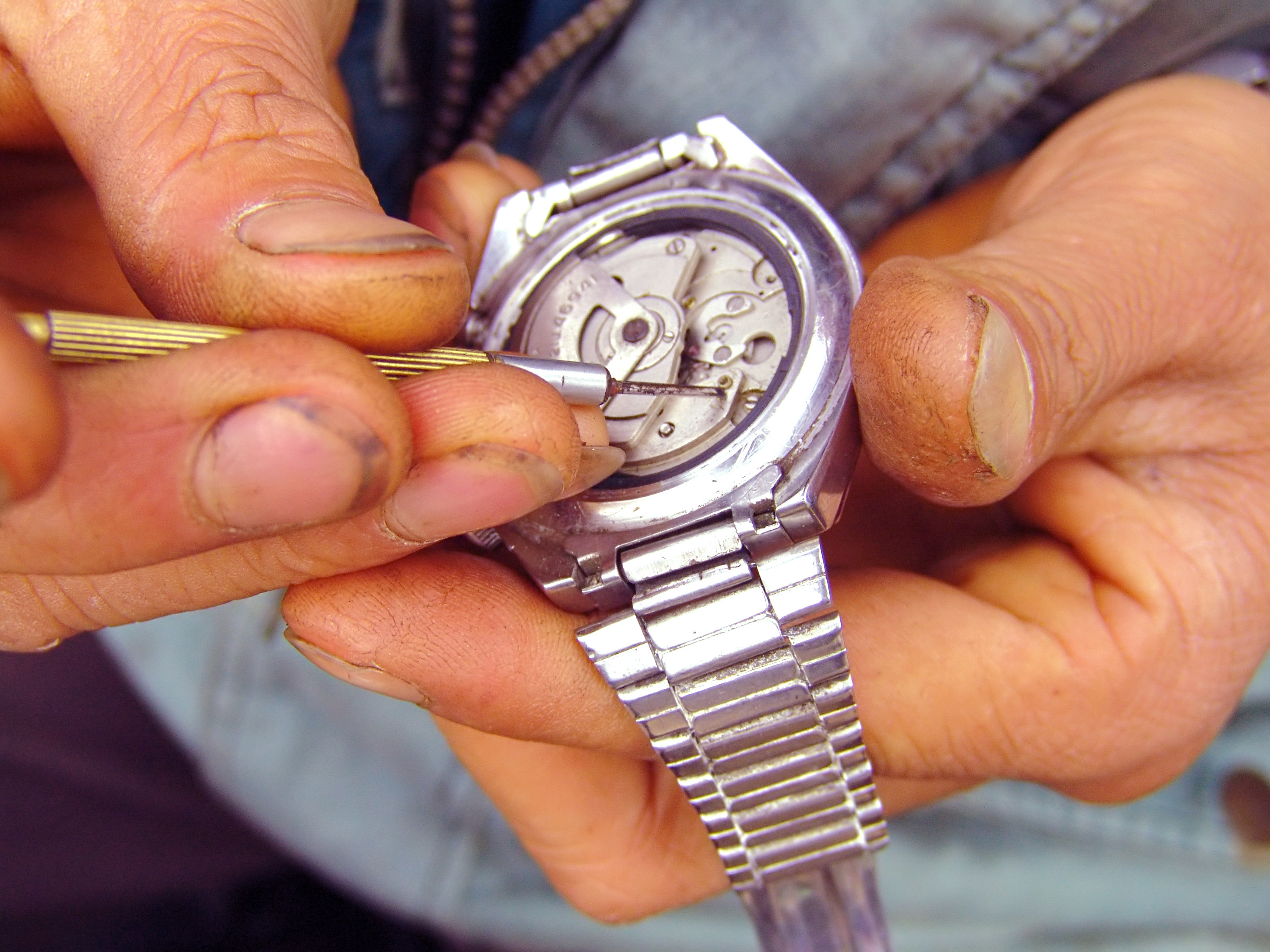 hands construct a wrist watch