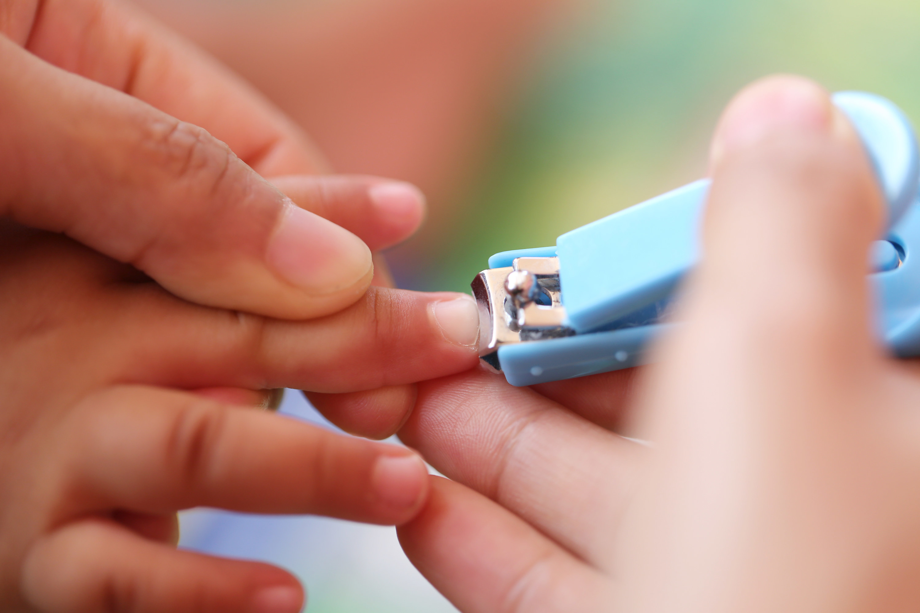 parent cutting baby nails