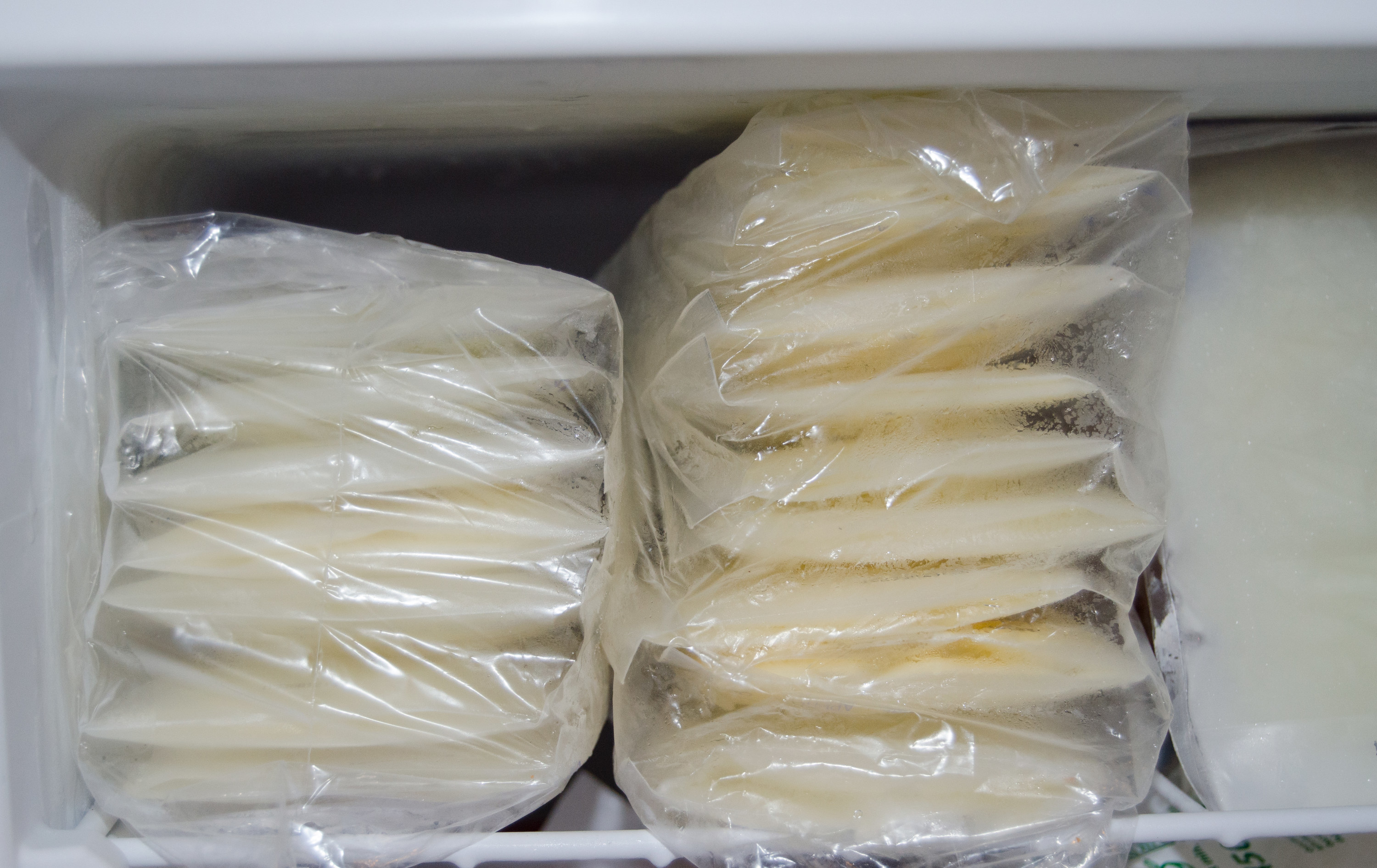 expressed breast milk packed in storage bags and frozen in the freezer