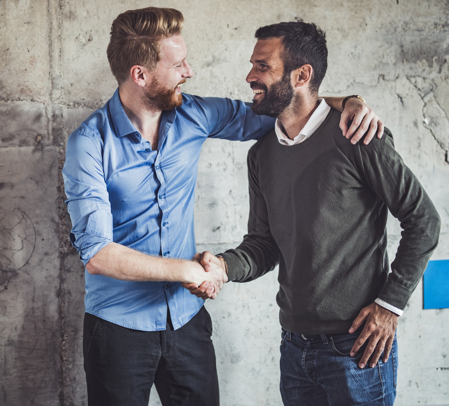 Two men shaking hands and smiling