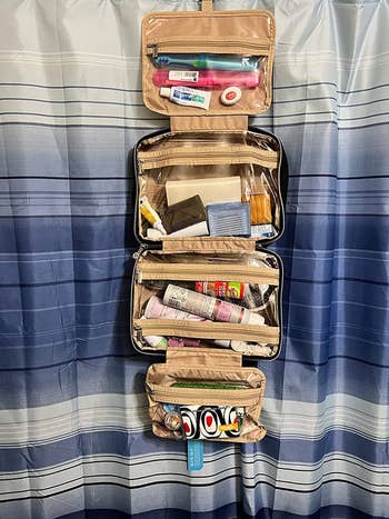 Same reviewer's photo of the toiletry bag, open and full of stuff