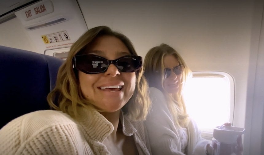 Raquel and Ariana sitting next to each other on an airplane