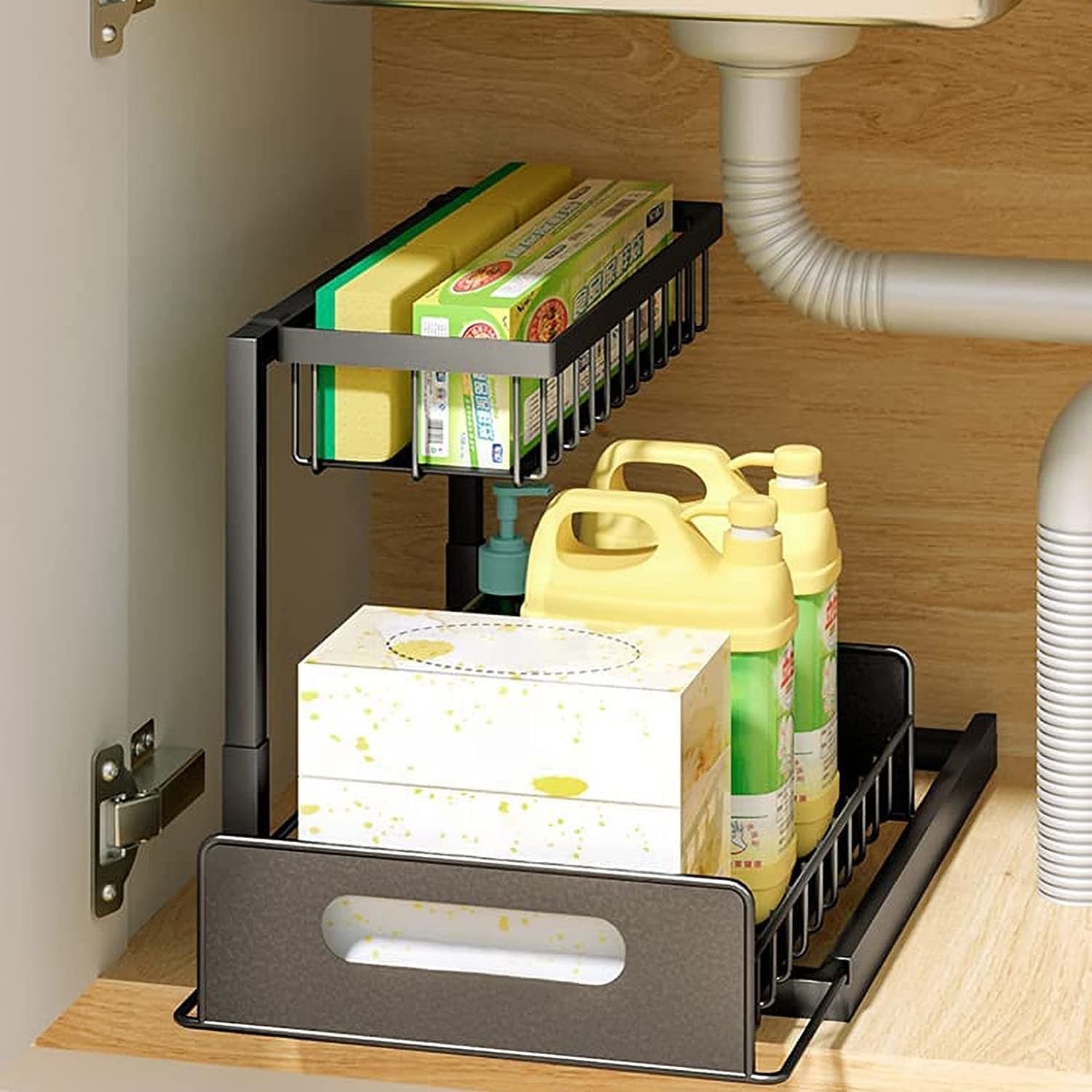 a two-tiered shelf filled with cleaning supplies that slides out in a cupboard under a sink