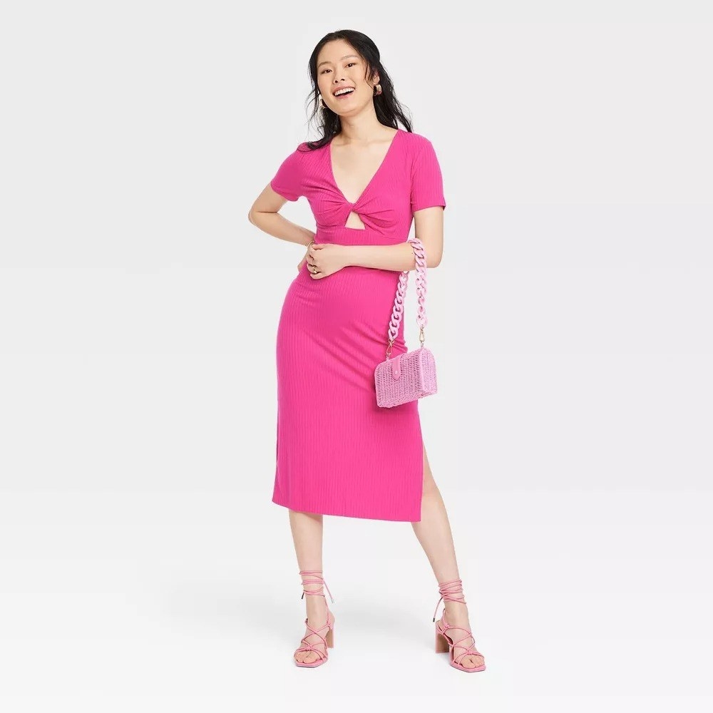 model wearing pink short sleeve cutout midi dress