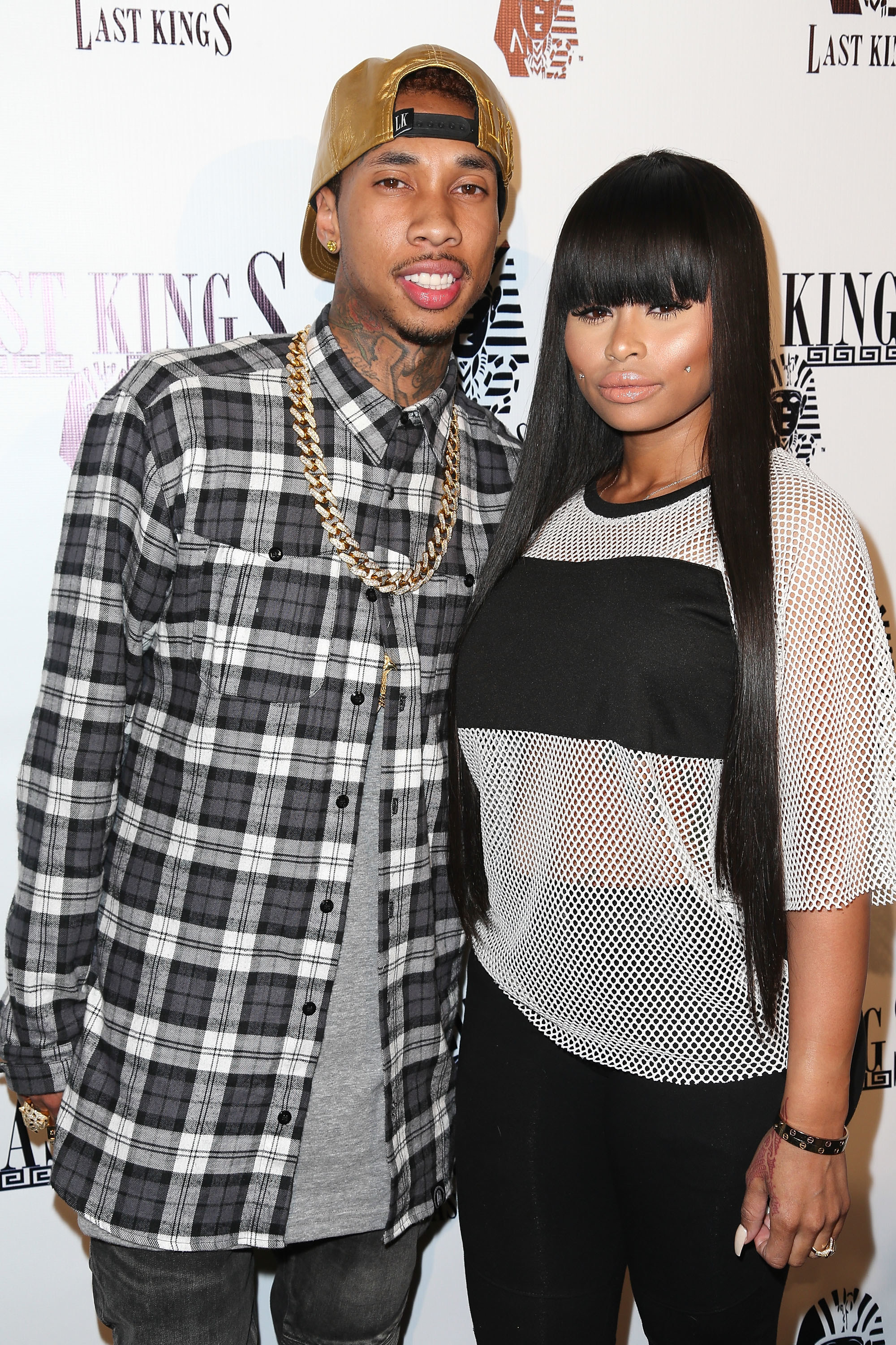 Tyga and Blac Chyna pose for a photo at a red carpet event