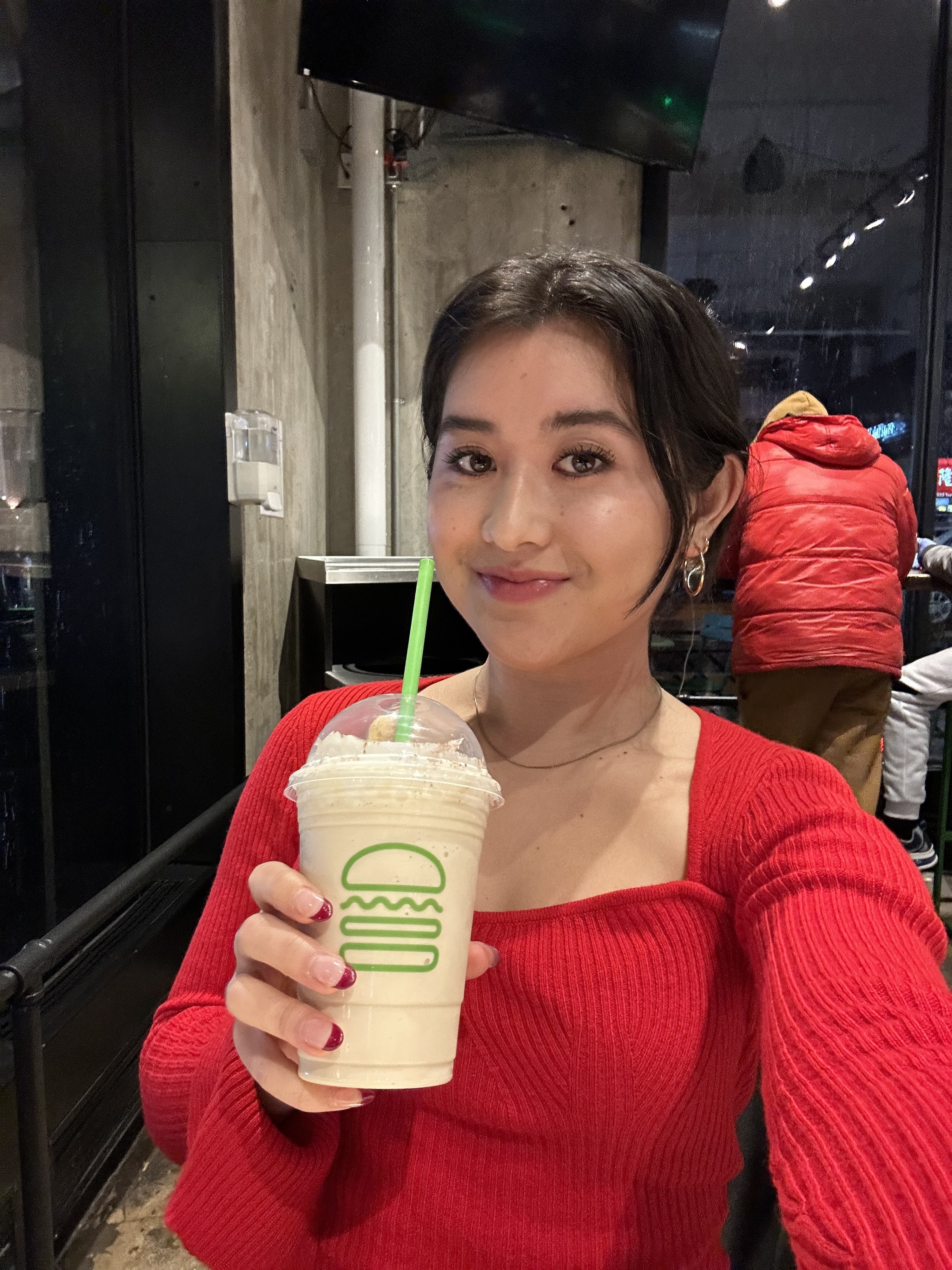 Woman holding the shake and smiling