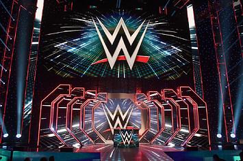 WWE logos are shown on screens before a WWE news conference at T-Mobile Arena.
