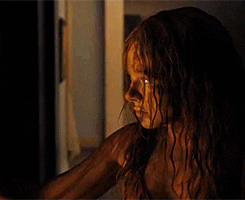 Chloë Grace Moretz covered in blood and looking serious in Carrie