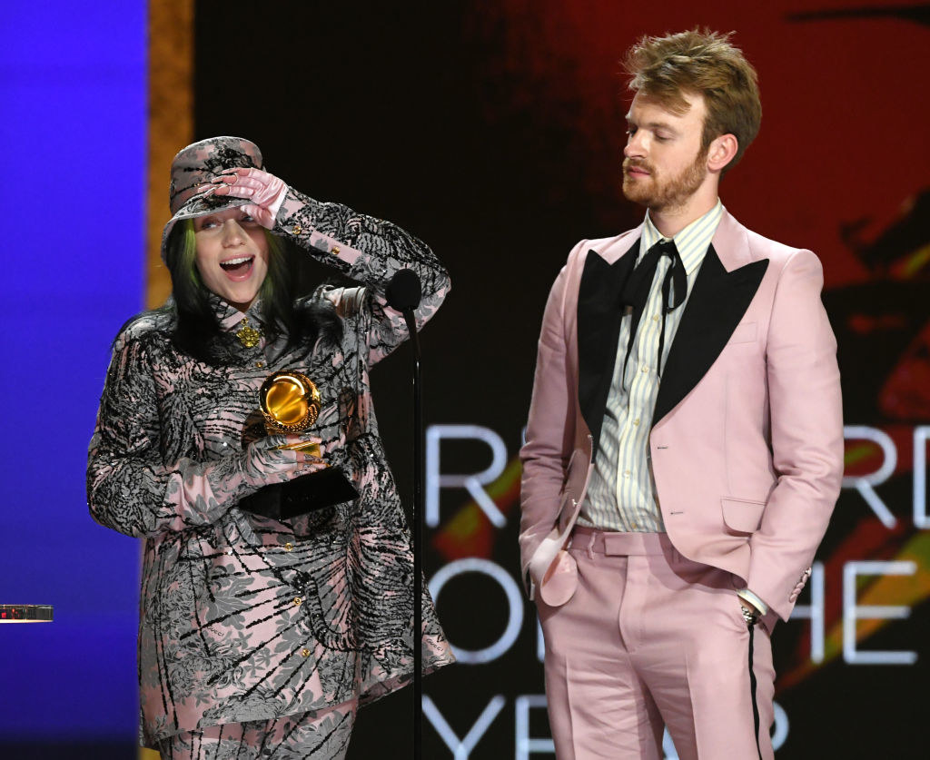 billie and finneas on stage with the award