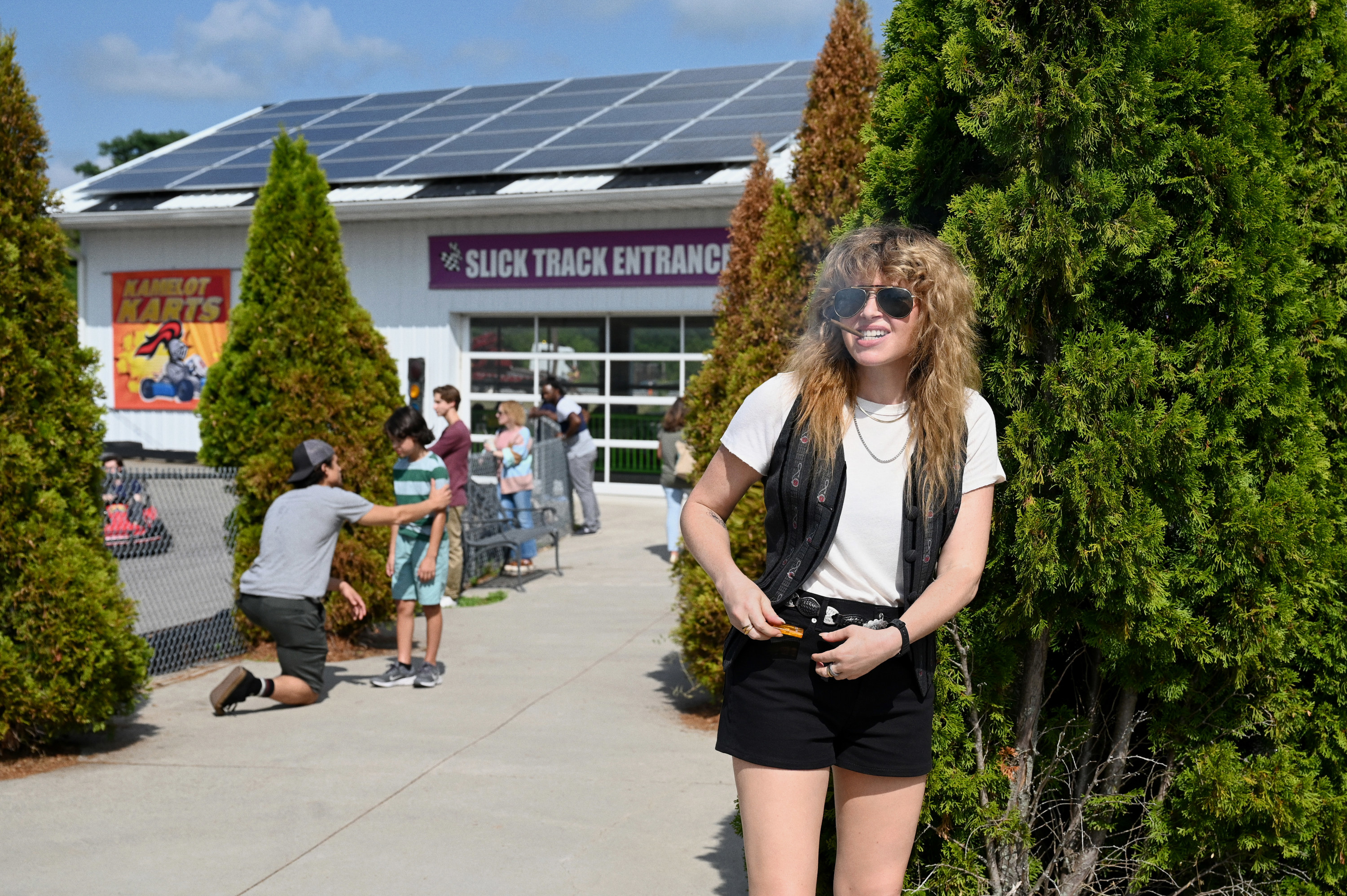 natasha smoking outside near a go-kart track