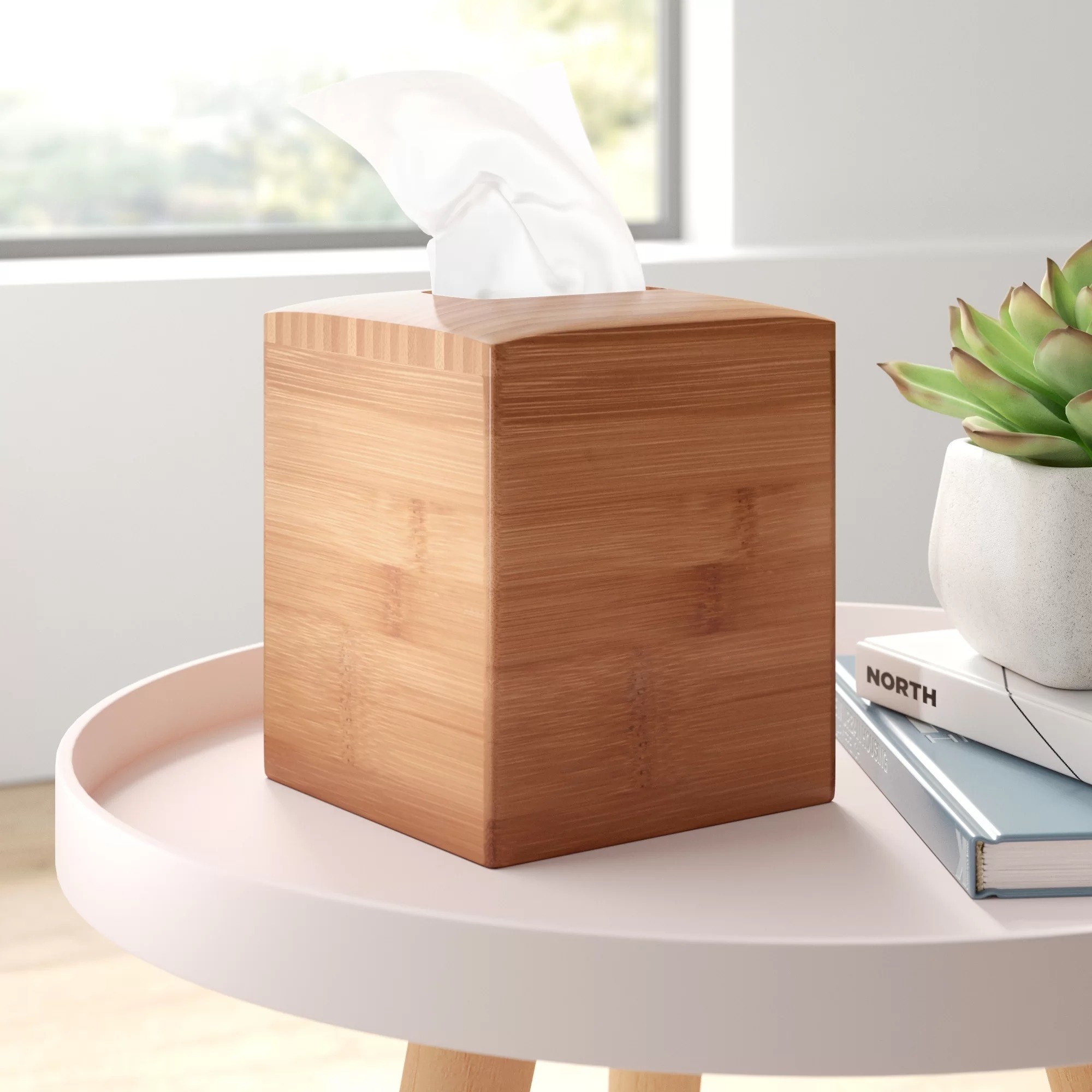 The wooden tissue box holder on a table