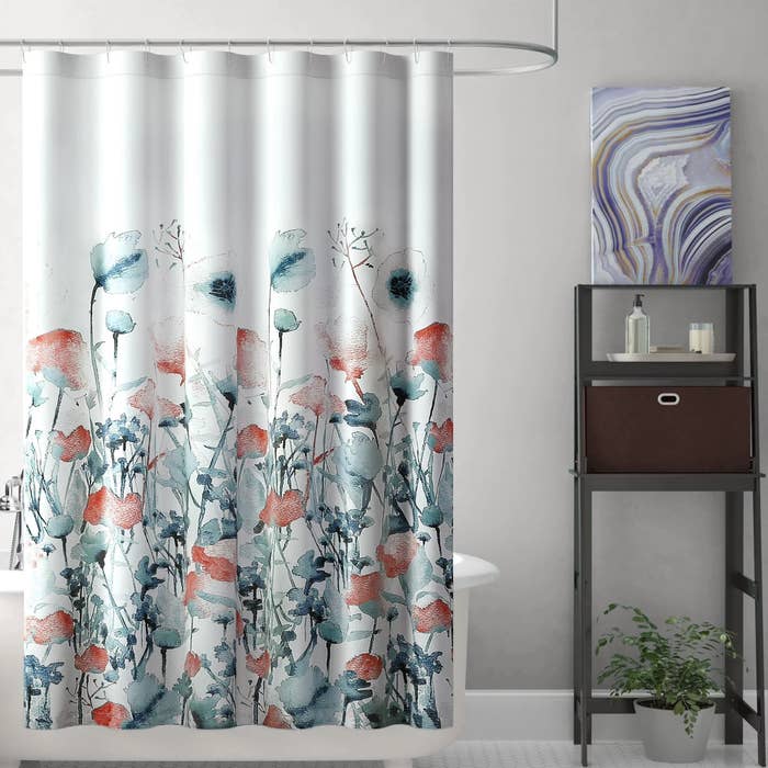 The floral-print curtain hanging in a shower